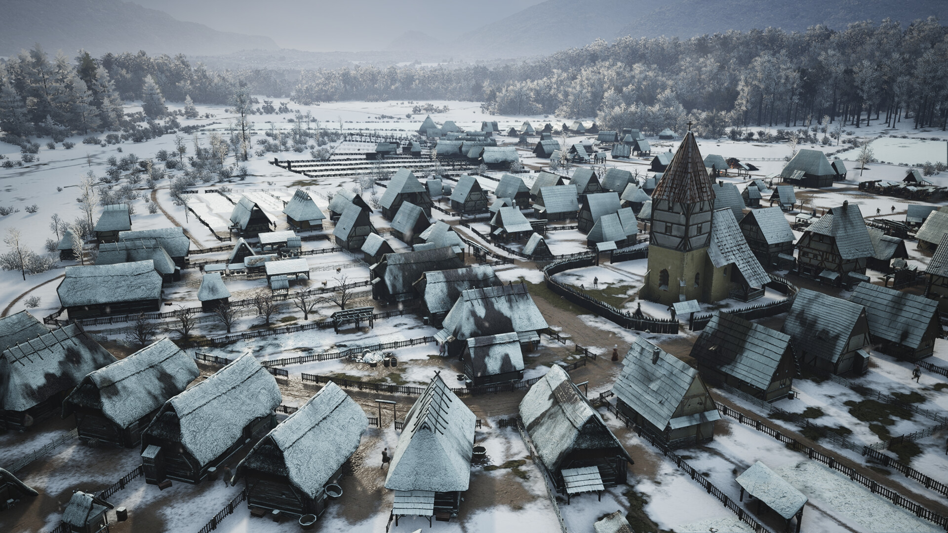 マナーロード 雪に覆われた冬の村と教会の塔がそびえる集落の全景